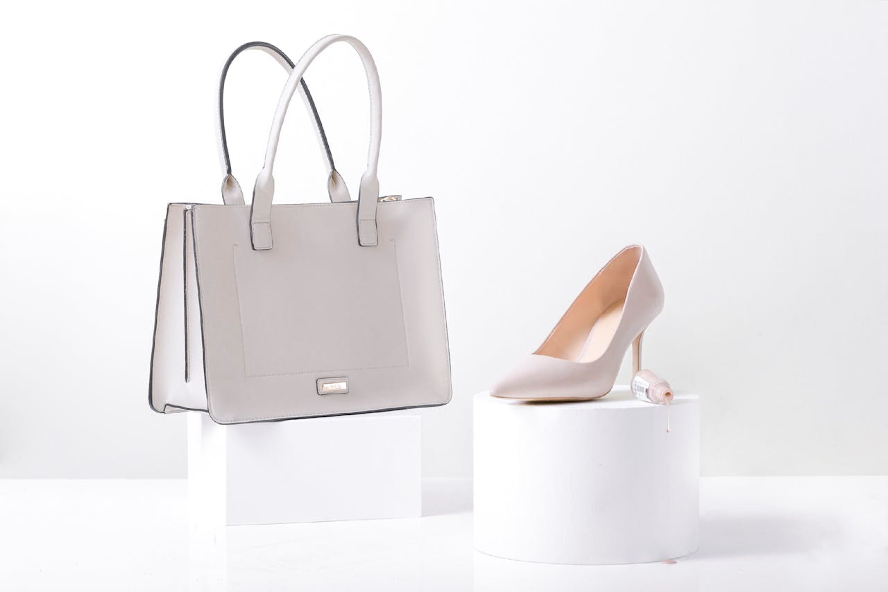 services-03 Stylish white leather handbag and heel on white background, highlighting elegance and simplicity.
