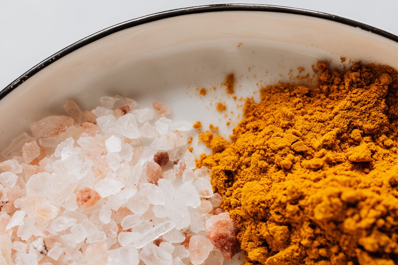 services-04 Close-up of pink Himalayan salt and turmeric powder creating a vibrant contrast.